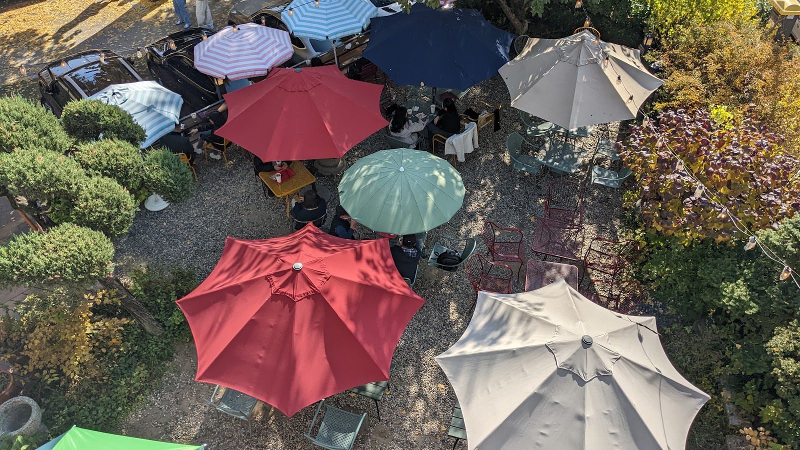 Café umbrellas in a Seoul courtyard seen from above