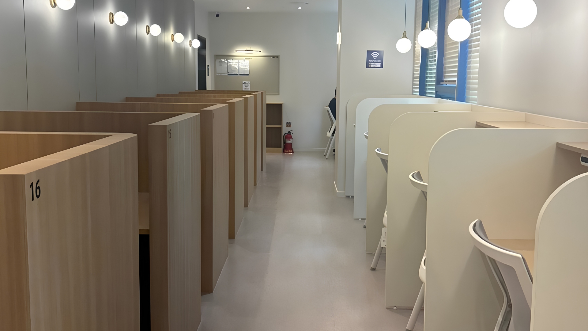 Rows of partitioned study desks in a Seoul study café