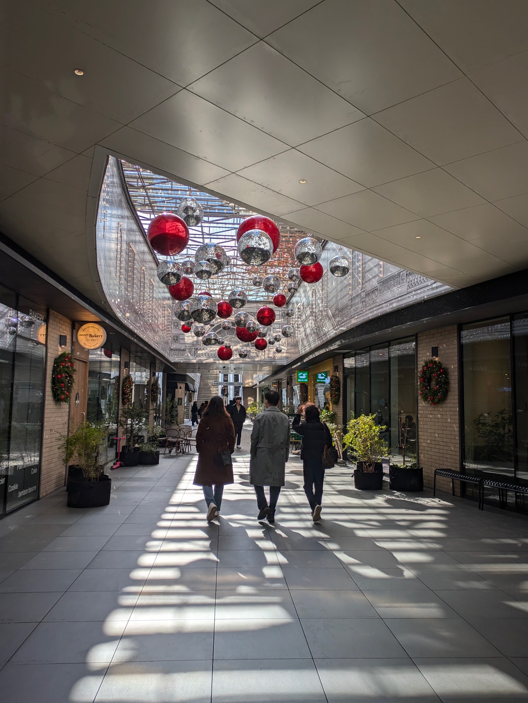 Shoppers walking through a covered Seoul shopping arcade